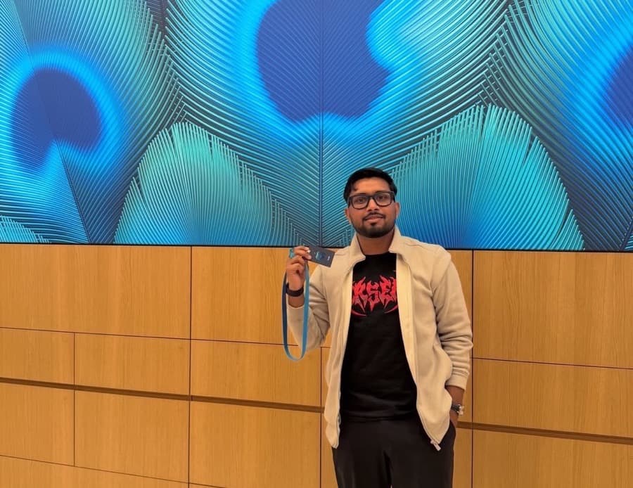 Manav at the Apple store launch in Noida, in front of the Apple wall